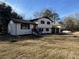 Two-story home featuring white painted brick, dark trim, and a well-manicured lawn at 2715 Heritage Ln, Morrow, GA 30260