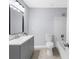 Modern bathroom with gray vanity, updated fixtures, and patterned floor at 2678 Greentree Se Dr, Marietta, GA 30067