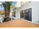 Back deck with brown stain, sliding glass door, and tree with climbing vines at 2678 Greentree Se Dr, Marietta, GA 30067