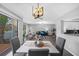 Open concept dining area with modern chandelier and access to patio at 2678 Greentree Se Dr, Marietta, GA 30067