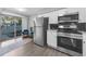 Updated kitchen with stainless steel appliances, and view to outdoor patio through sliding glass doors at 2678 Greentree Se Dr, Marietta, GA 30067
