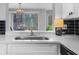 Modern kitchen with stone counters, view of backyard through slider, and stainless faucet at 2678 Greentree Se Dr, Marietta, GA 30067