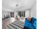 Open concept living room with blue couch and access to patio at 2678 Greentree Se Dr, Marietta, GA 30067
