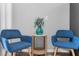 Cozy living area boasts gray walls, blue chairs and a decorative table with plant for relaxing at 2678 Greentree Se Dr, Marietta, GA 30067