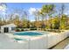 Community pool covered by tarp with nearby pool house surrounded by fencing and trees at 2678 Greentree Se Dr, Marietta, GA 30067