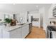 White kitchen with granite countertops, island, and stainless steel appliances at 7049 Brushwood Bend (Lot 59), Lithonia, GA 30058