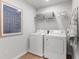 Convenient laundry room with washer, dryer, and shelving at 7049 Brushwood Bend (Lot 59), Lithonia, GA 30058