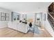 Spacious living room featuring hardwood floors, large windows, and a comfortable sectional sofa at 7049 Brushwood Bend (Lot 59), Lithonia, GA 30058