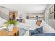 Open concept living room with sectional sofa and view into kitchen at 7049 Brushwood Bend (Lot 59), Lithonia, GA 30058