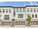 Modern townhome with brick accents, two-car garage, covered entry, and black window trim at 215 Arizona Ne Ave # 2, Atlanta, GA 30307