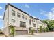 Angle shot of a row of modern townhomes featuring brick and attached garages at 215 Arizona Ne Ave # 2, Atlanta, GA 30307