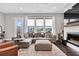 Bright living room featuring a sectional sofa, modern fireplace, and outdoor access at 215 Arizona Ne Ave # 2, Atlanta, GA 30307