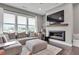 Cozy living room featuring a sectional sofa, fireplace, and large windows with natural light at 215 Arizona Ne Ave # 2, Atlanta, GA 30307