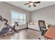 Modern office/flex space features a Peloton bike, pull out sofa, wood floors, and ceiling fan at 215 Arizona Ne Ave # 2, Atlanta, GA 30307