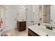 Bathroom featuring double sink vanity, neutral walls, tile flooring and view of bath/shower at 313 Pennant Ln, Fairburn, GA 30213