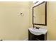 Cozy powder room featuring a vanity with a dark wood cabinet and a decorative mirror at 313 Pennant Ln, Fairburn, GA 30213