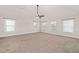 Large empty bedroom with plush carpet, neutral walls, and several windows for natural light at 313 Pennant Ln, Fairburn, GA 30213
