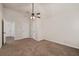 Bedroom showcasing plush carpeting, a ceiling fan, and multiple doors leading to other rooms in the house at 313 Pennant Ln, Fairburn, GA 30213