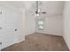 Bright bedroom featuring neutral walls, carpet floors, a ceiling fan, and a window providing natural light at 313 Pennant Ln, Fairburn, GA 30213