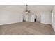 Large, spacious bedroom with neutral walls, carpet floors, and multiple entryways at 313 Pennant Ln, Fairburn, GA 30213