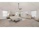Brightly lit bedroom with a bed, sitting area, multiple windows and neutral carpet at 313 Pennant Ln, Fairburn, GA 30213