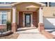 Brick front porch with columns and a black front door at 313 Pennant Ln, Fairburn, GA 30213
