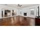 Spacious living room with fireplace, hardwood floors, and open access to adjacent rooms at 313 Pennant Ln, Fairburn, GA 30213
