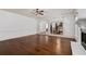 Bright living room with gleaming hardwood floors, a fireplace, and open access to other rooms at 313 Pennant Ln, Fairburn, GA 30213