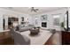 Bright living room boasts a fireplace, ample seating, and an open layout to the kitchen at 313 Pennant Ln, Fairburn, GA 30213