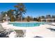 Community swimming pool with lounge chairs and clubhouse with pergola in the background at 313 Pennant Ln, Fairburn, GA 30213