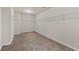 Spacious walk-in closet featuring neutral carpet and built-in shelving for organized storage at 313 Pennant Ln, Fairburn, GA 30213