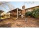 Brick home's backyard features covered deck and mature shrubbery at 4453 White Oak Dr, Sugar Hill, GA 30518