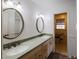 This spacious bathroom is equipped with double sinks, a granite countertop, and updated vanities at 4453 White Oak Dr, Sugar Hill, GA 30518