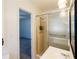 A renovated bathroom with a glass shower door is conveniently located off of the bedroom at 4453 White Oak Dr, Sugar Hill, GA 30518