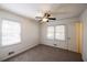 This bedroom features carpet, a ceiling fan, and windows for natural light at 4453 White Oak Dr, Sugar Hill, GA 30518