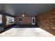 Carport with brick wall, showing entrances to the home and concrete flooring at 4453 White Oak Dr, Sugar Hill, GA 30518