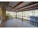 Spacious covered deck features wood flooring, metal awning, and wrought iron railings at 4453 White Oak Dr, Sugar Hill, GA 30518