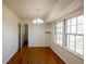 Sunny dining room boasting hardwood floors and a stylish chandelier, perfect for intimate gatherings at 4453 White Oak Dr, Sugar Hill, GA 30518