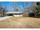 Charming single-story home with a brick facade, attached carport, and a spacious front lawn at 4453 White Oak Dr, Sugar Hill, GA 30518