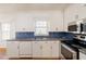 Charming kitchen featuring white cabinets, stainless steel appliances, and plenty of counter space at 4453 White Oak Dr, Sugar Hill, GA 30518