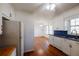 Bright kitchen featuring white cabinets, hardwood floors and stainless steel appliances at 4453 White Oak Dr, Sugar Hill, GA 30518