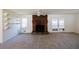 Open living room with brick fireplace and exposed shelving, offering a cozy and functional space at 4453 White Oak Dr, Sugar Hill, GA 30518