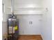 Functional utility room with shelving and a water heater, providing essential storage and convenience at 4453 White Oak Dr, Sugar Hill, GA 30518
