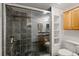 Modern bathroom with a large glass shower and wood cabinets at 5200 Peachtree Rd # 3116, Chamblee, GA 30341