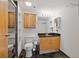 Clean bathroom, featuring wood cabinets and dark tile floors at 5200 Peachtree Rd # 3116, Chamblee, GA 30341