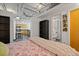 Bedroom with queen bed, built-in shelves, and kitchen view at 5200 Peachtree Rd # 3116, Chamblee, GA 30341