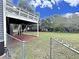 Spacious backyard featuring a wooden deck, green lawn, and chain-link fence at 305 Rampart St, Mcdonough, GA 30253