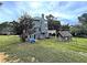 Backyard view of a two-story home with a large yard and wooden deck at 305 Rampart St, Mcdonough, GA 30253