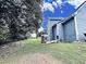 Backyard featuring stairs to upper porch, fenced in area, and landscaped greenery at 305 Rampart St, Mcdonough, GA 30253