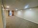 Basement with carpet and a door that leads to the outside at 305 Rampart St, Mcdonough, GA 30253